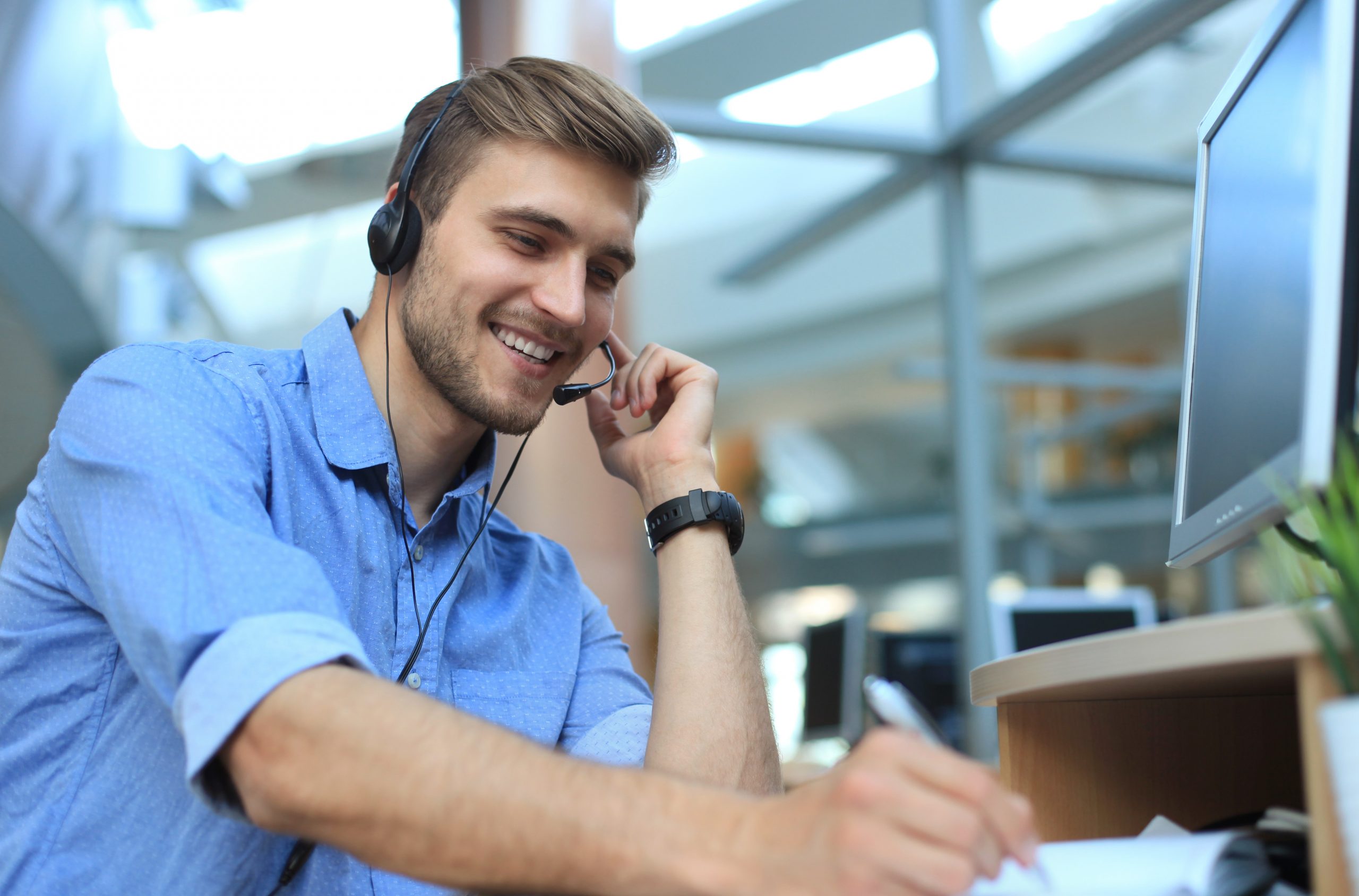 Smiling friendly handsome young male call centre operator